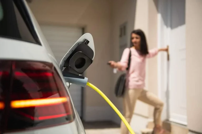 Woman charging electric car